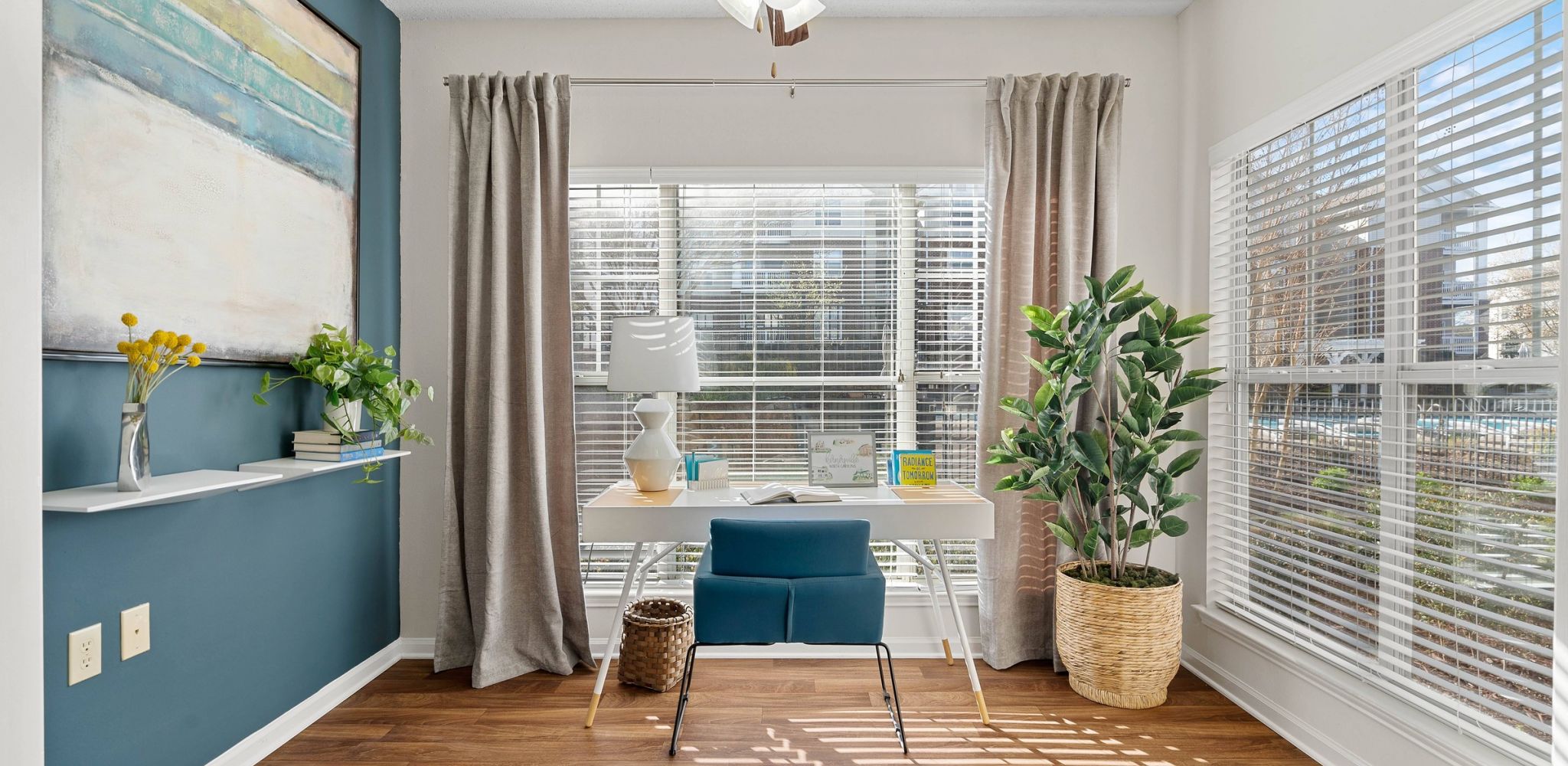 Hawthorne at Main apartment living space with large windows and hardwood inspired flooring