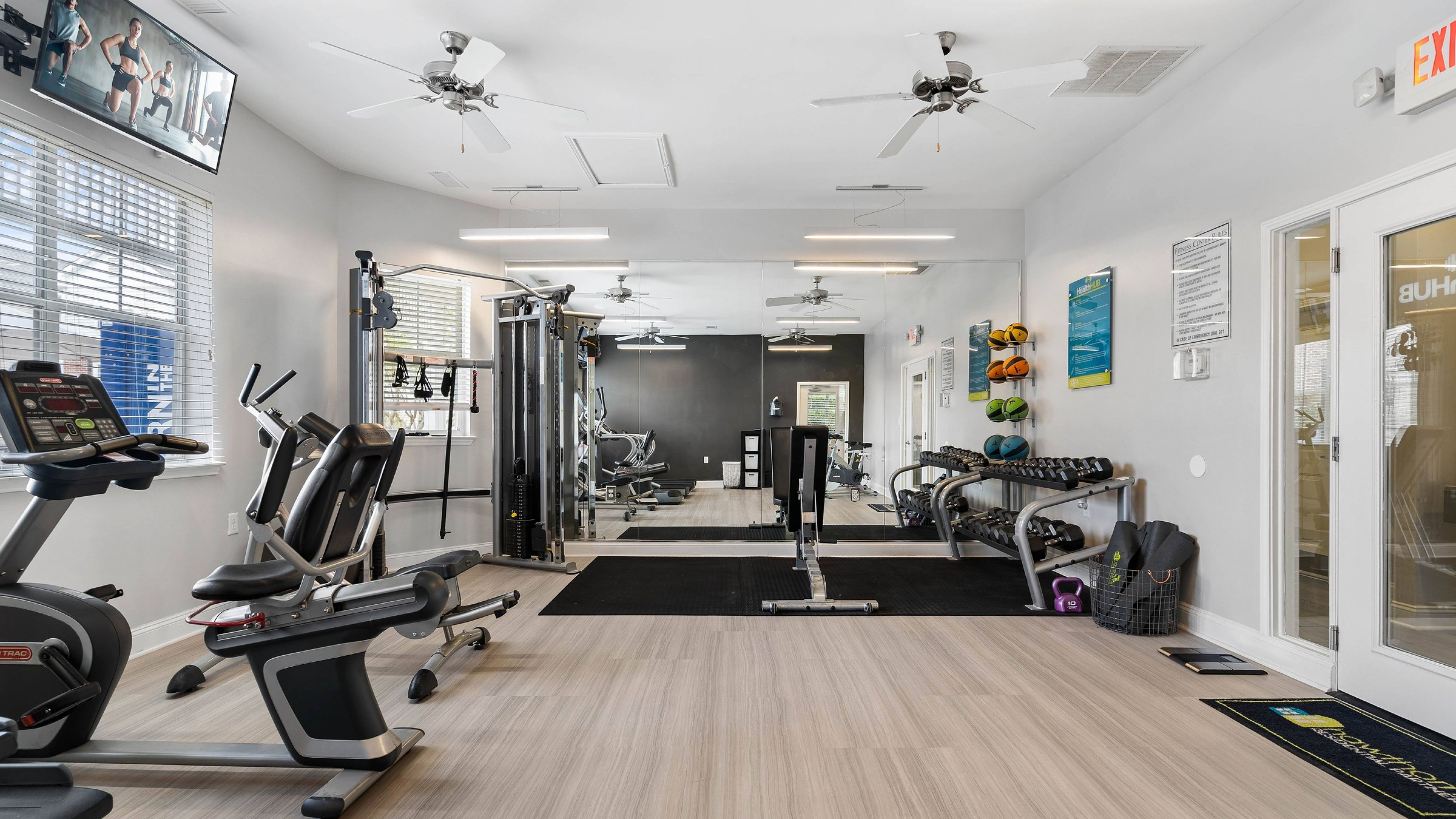 Hawthorne at Main resident fitness center amenity with cardio machines and tvs